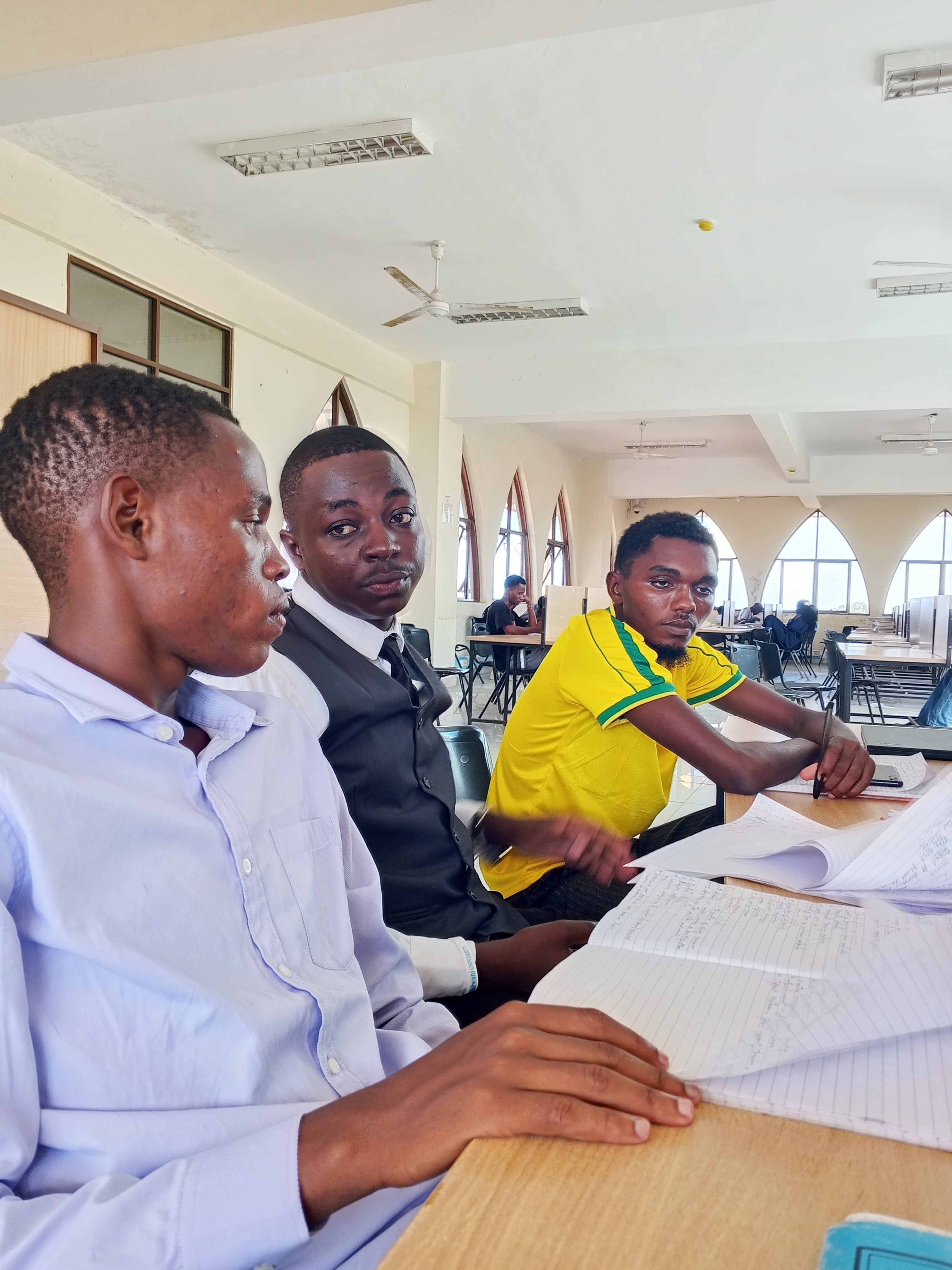 A group working together with notebooks in a study space